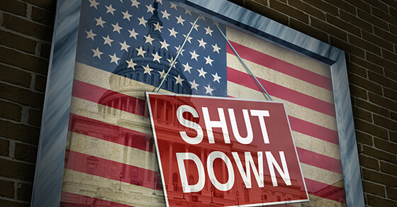 Government Shut Down sign on American flag.